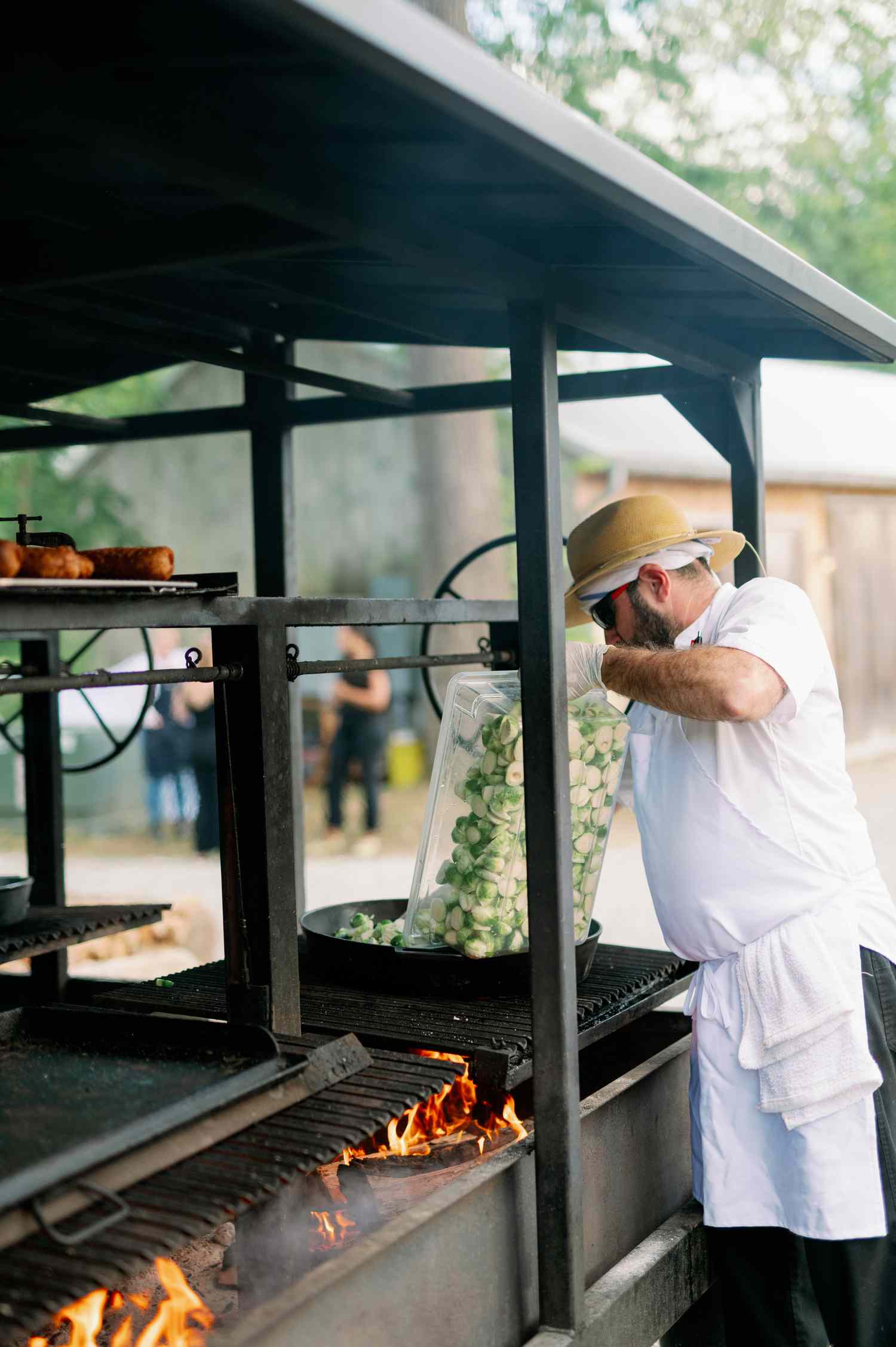 chef cooking outside at backyard wedding