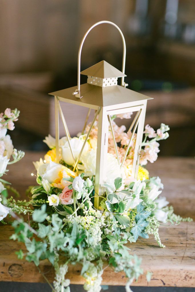 boxy lantern with spring flowers on wood table