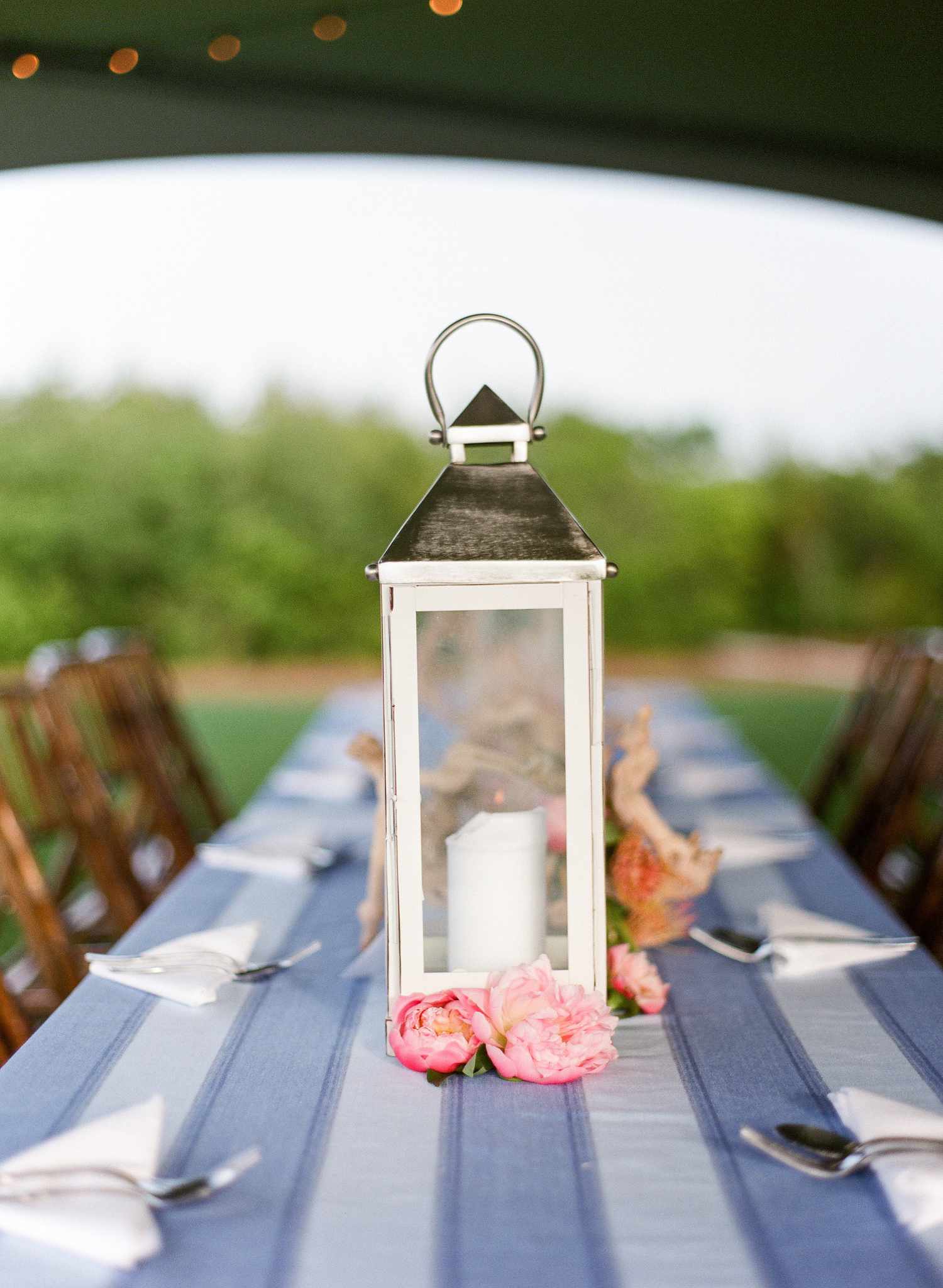 white lantern with nautical navy striped tablecloth and pink peonies