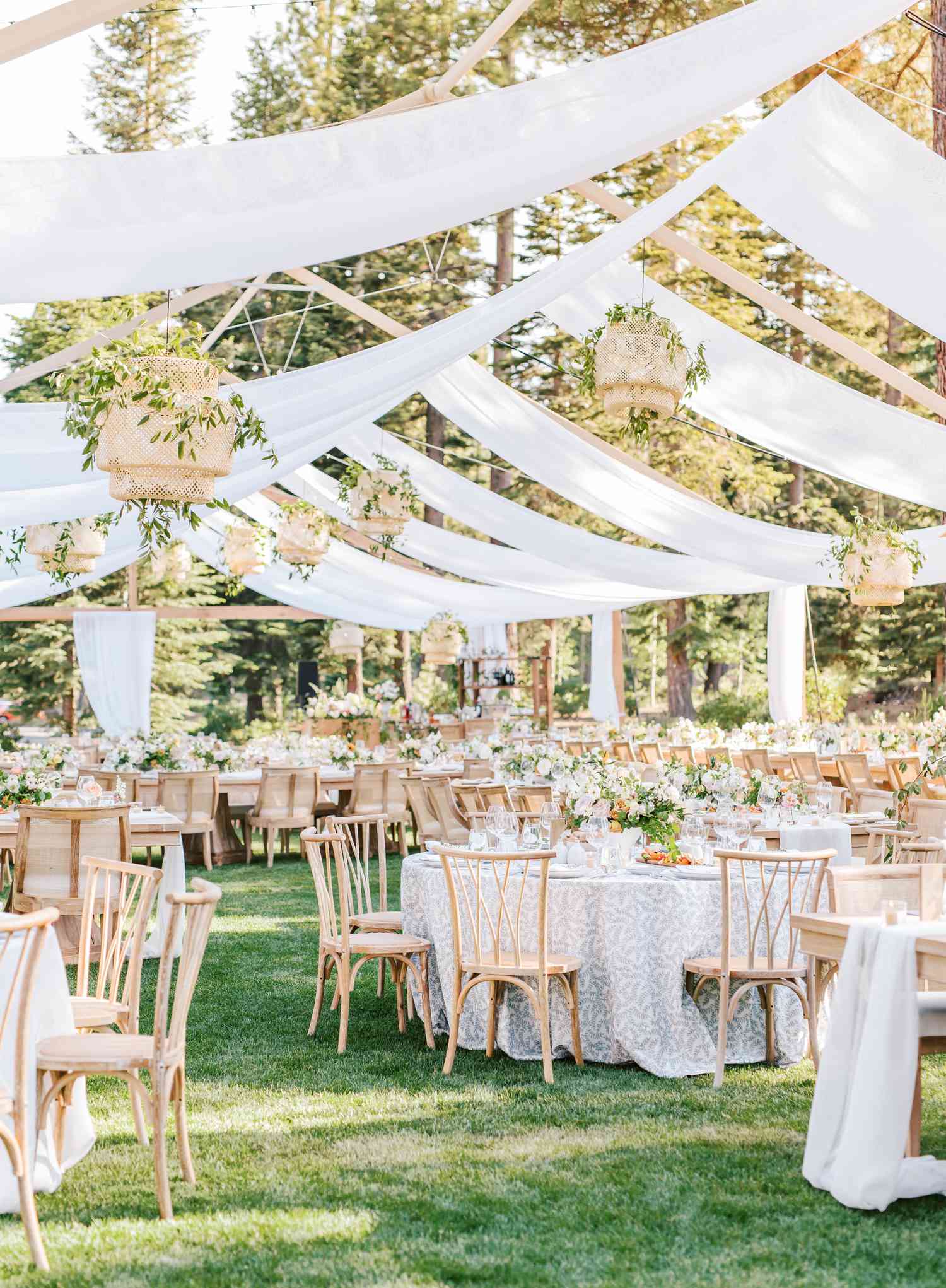 outdoor reception with round tables and panel draping overhead