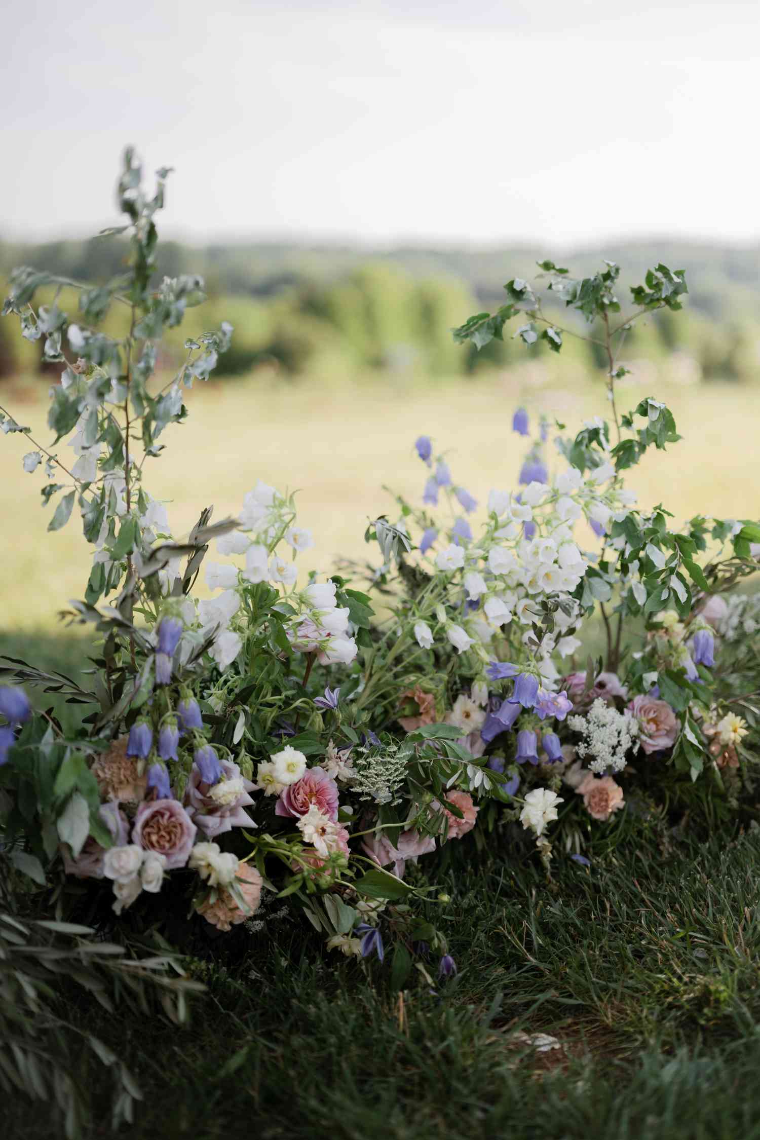 Floral installation with purple foxglove in grass