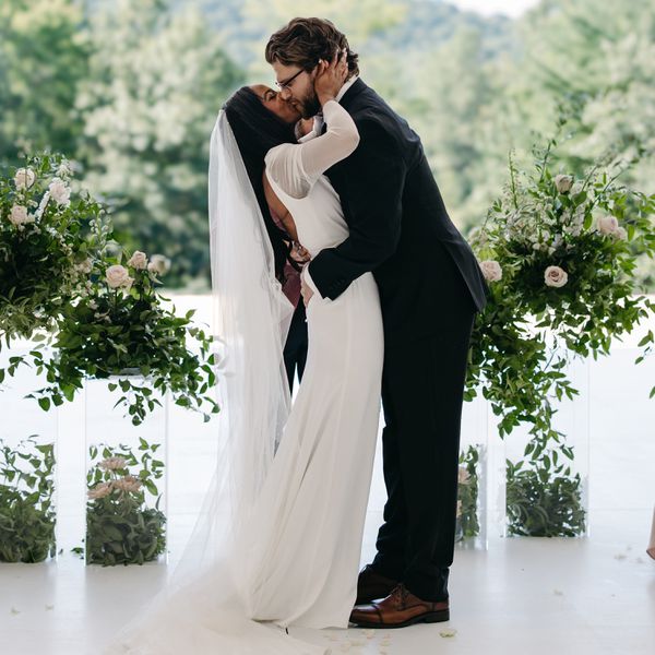 bride and groom kissing at the altar