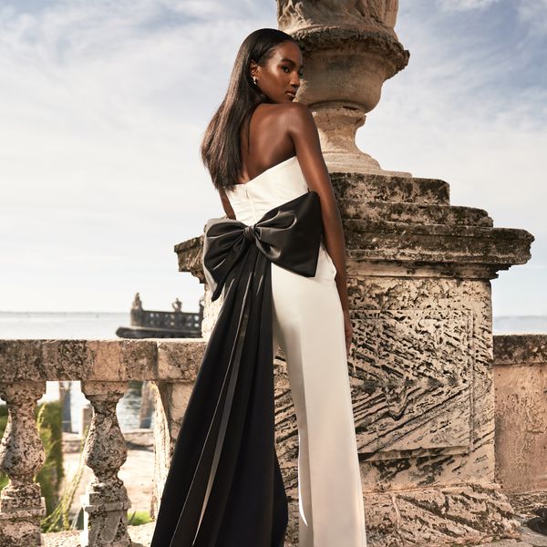Strapless Corset Top With White Pants and Large Black Bow in Back