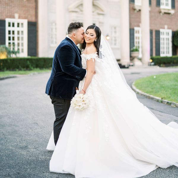 Side Profile of Brunette Groom in Navy Velvet About to Kiss Brunette Bride's Cheek