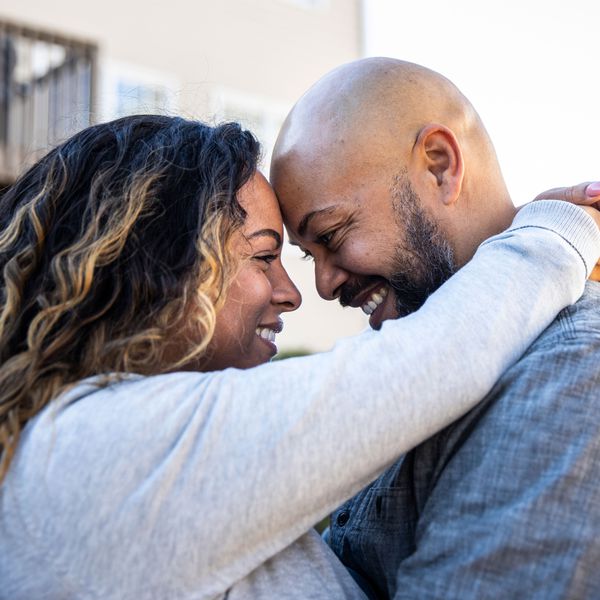 Woman and Man Looking into Each Otherâs Eyes and Embracing