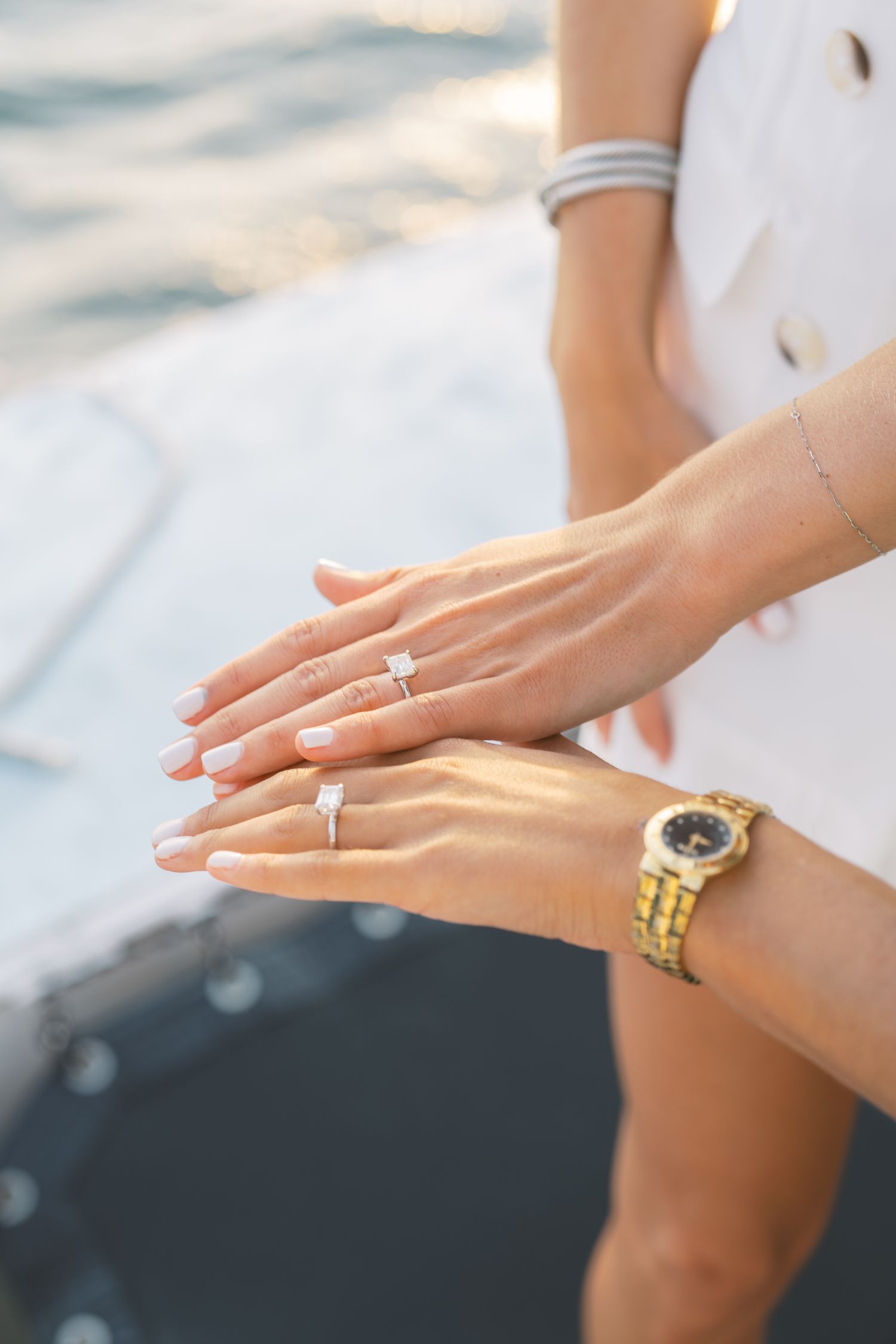 two brides showing off their diamond engagement rings
