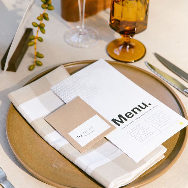 place setting with a modern menu and vintage glassware