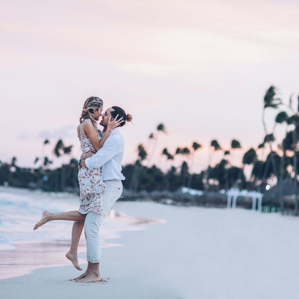 A couple kissing on the beach during sunset