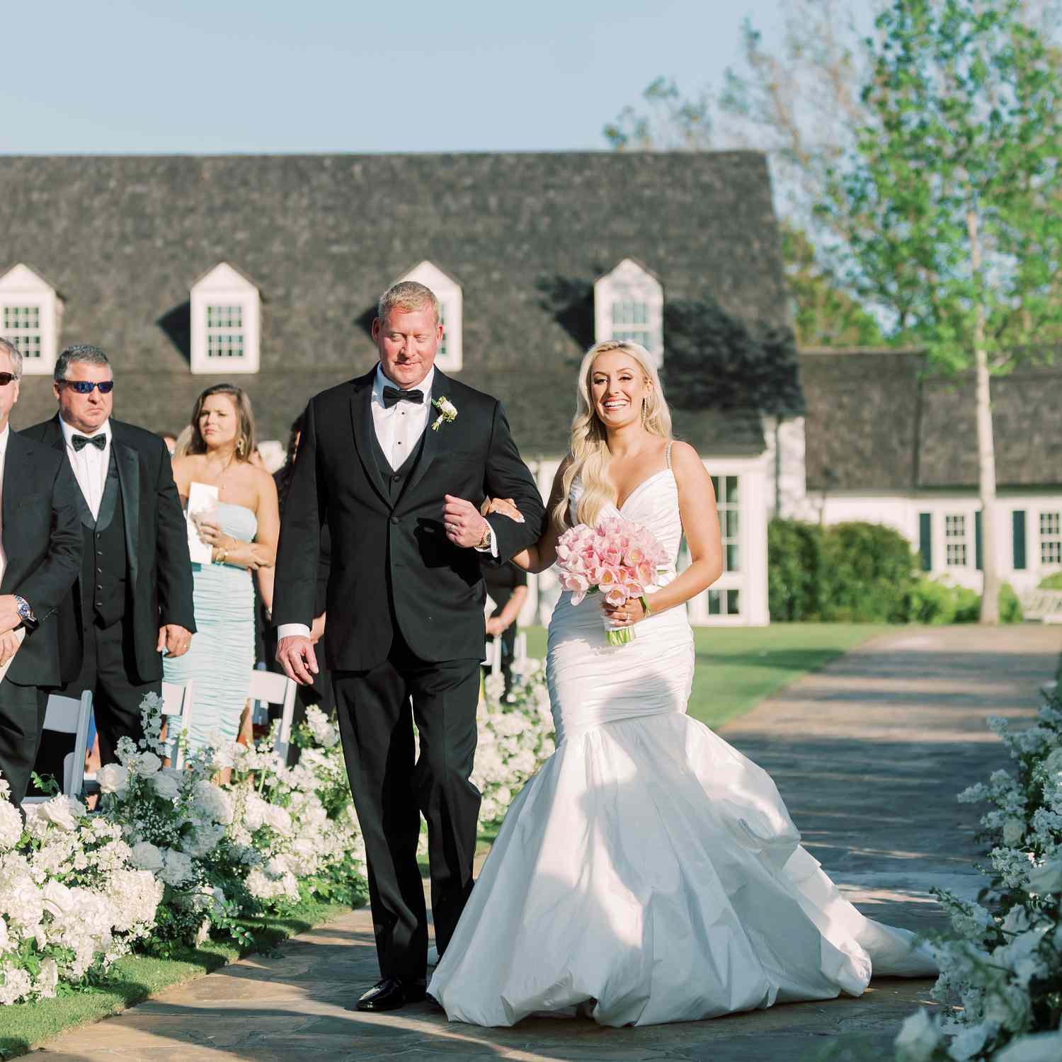 a bride and her father walking down the aisle together