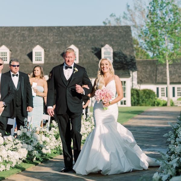 a bride and her father walking down the aisle together