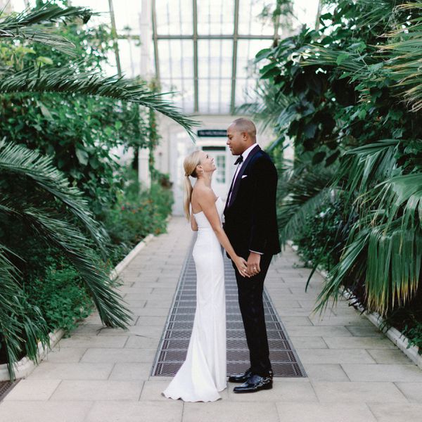 bride and groom holding hands looking into each other's eyes