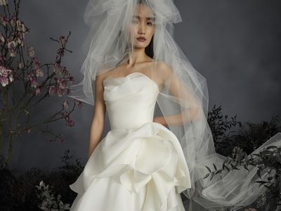 bride wearing a full tulle veil and corset bodice wedding ball gown