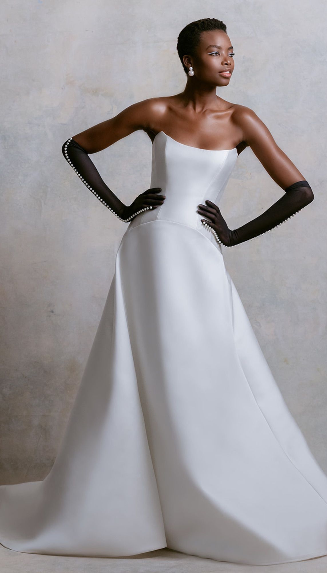 Strapless White Wedding Dress With Black Gloves Lined With Pearls and Matching Pearl Earrings