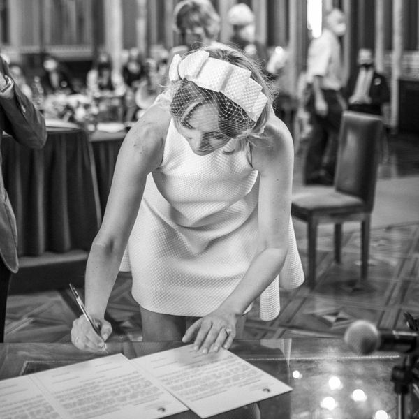bride signing a marriage license at church