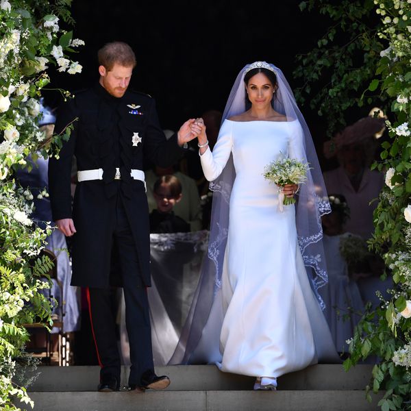 Meghan Markle wearing a Givenchy wedding gown, walking with Prince Harry on their wedding day in London in 2018.