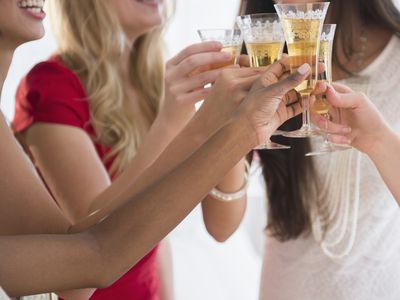 Group of Women Holding Champagne Glasses and Smiling