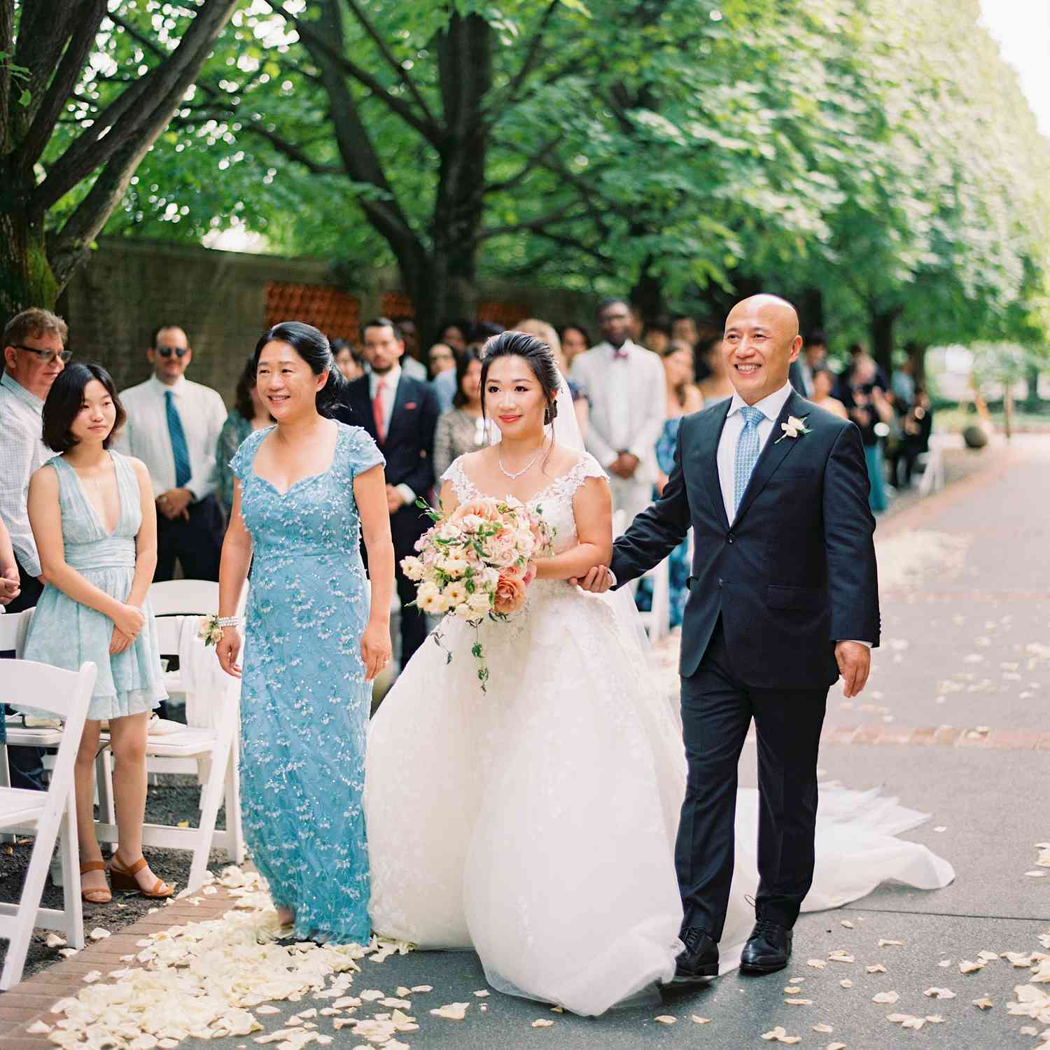 Mother of the Bride, Bride, and Father of the Bride Walking Down the Aisle
