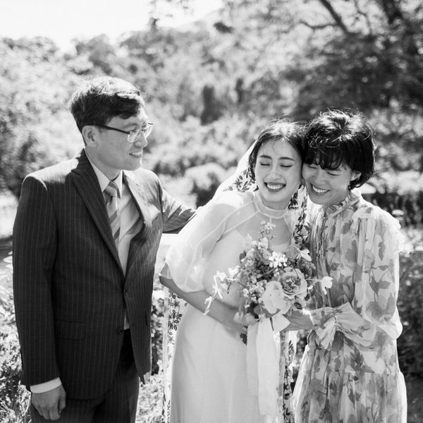 Bride Hugging Mother of the Bride in Modest Long-Sleeve Floral Dress