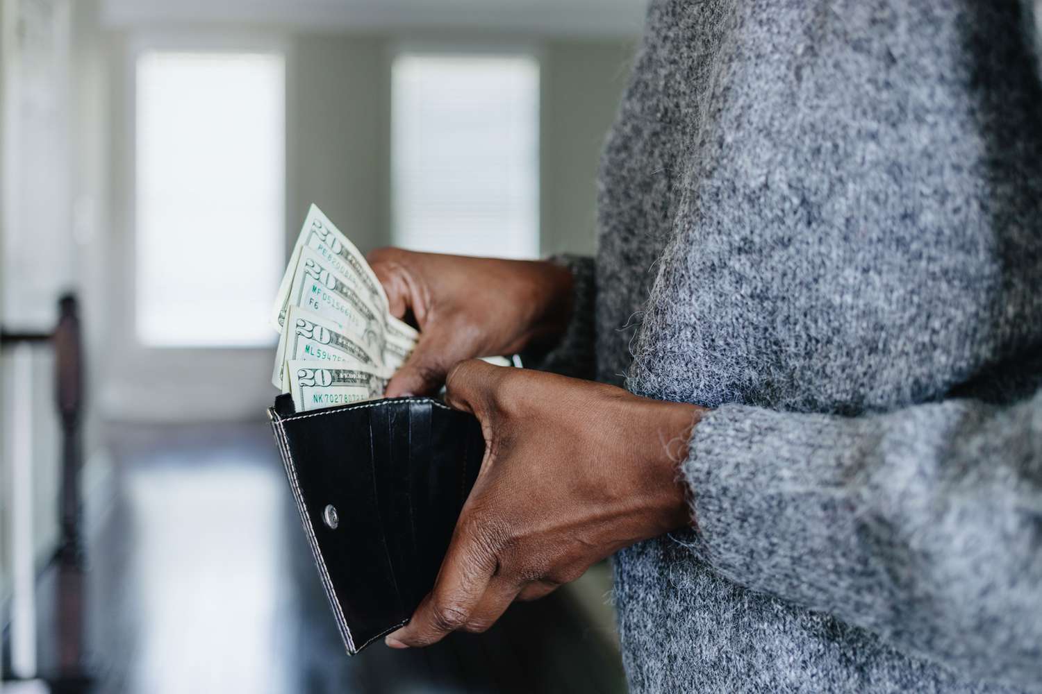 Woman getting money out of her wallet