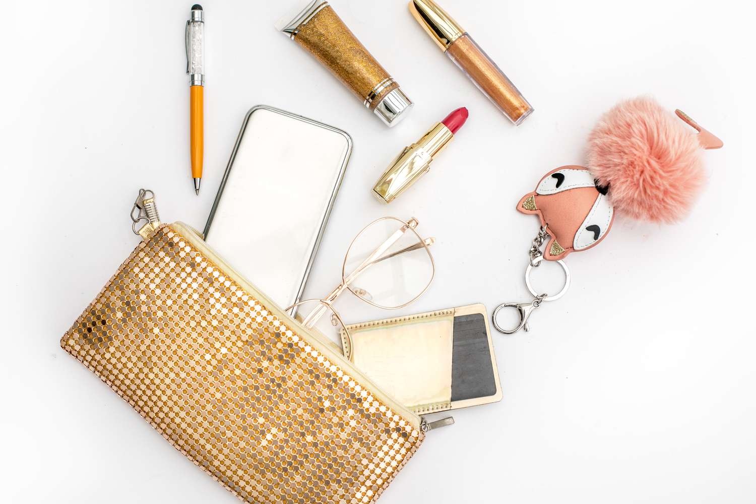Gold sequined clutch with personal belongings