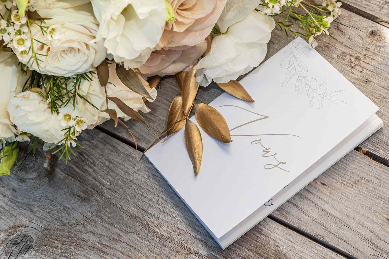 Vow booklet next to floral arrangements