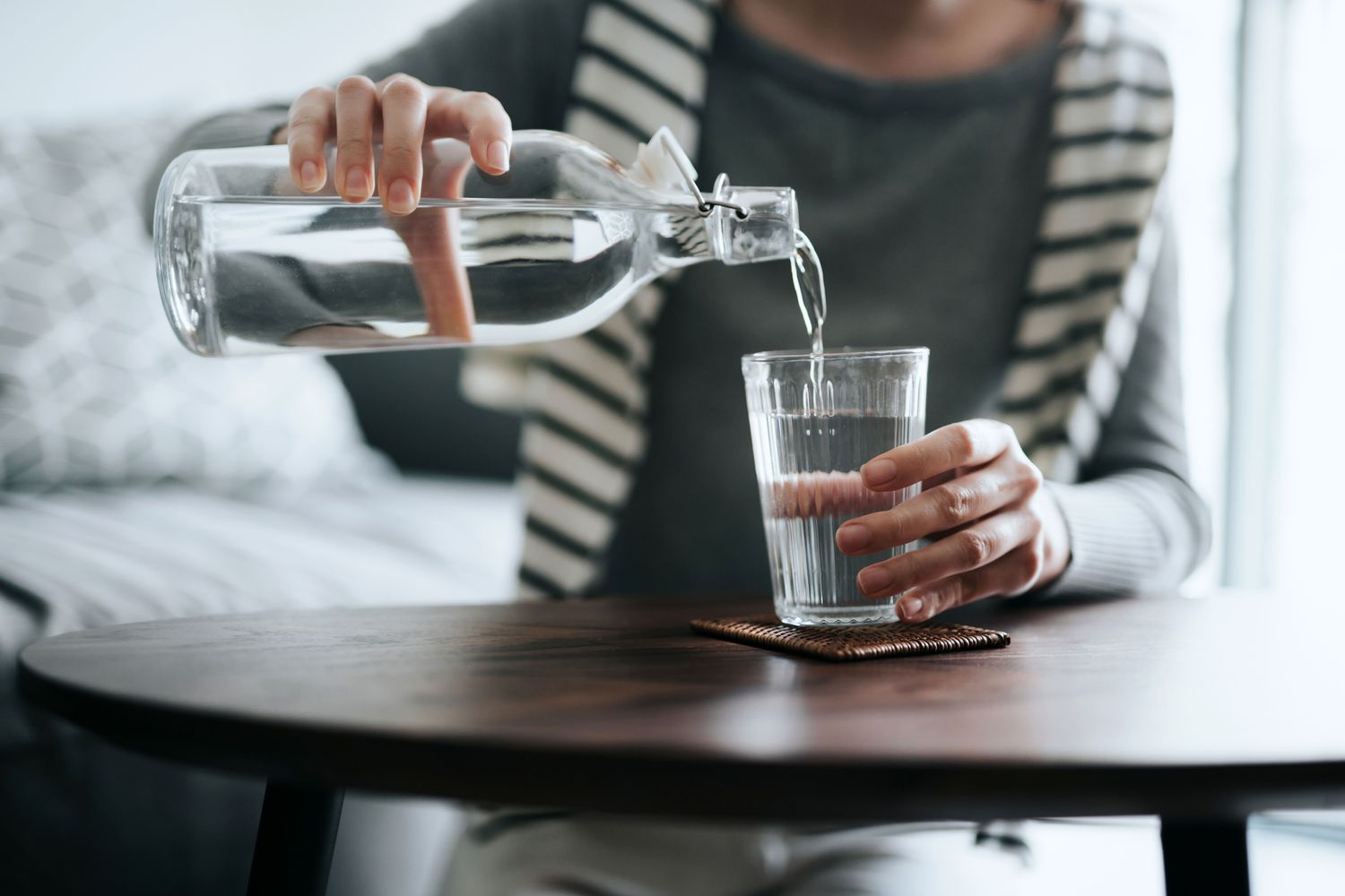 Woman pouring a glass of water