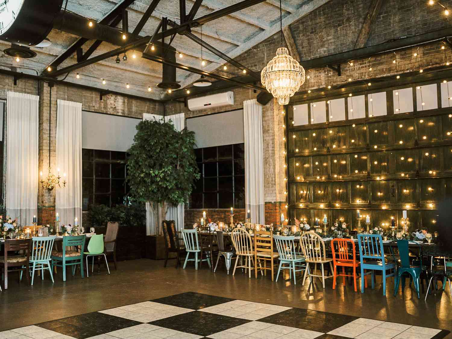 Soho South Cafe wedding reception set with colorful mismatched chairs and a black and white dance floor.