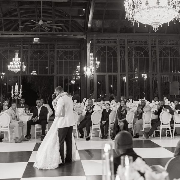 Bride and Groom Sharing First Dance on Black and White Checked Dance Floor