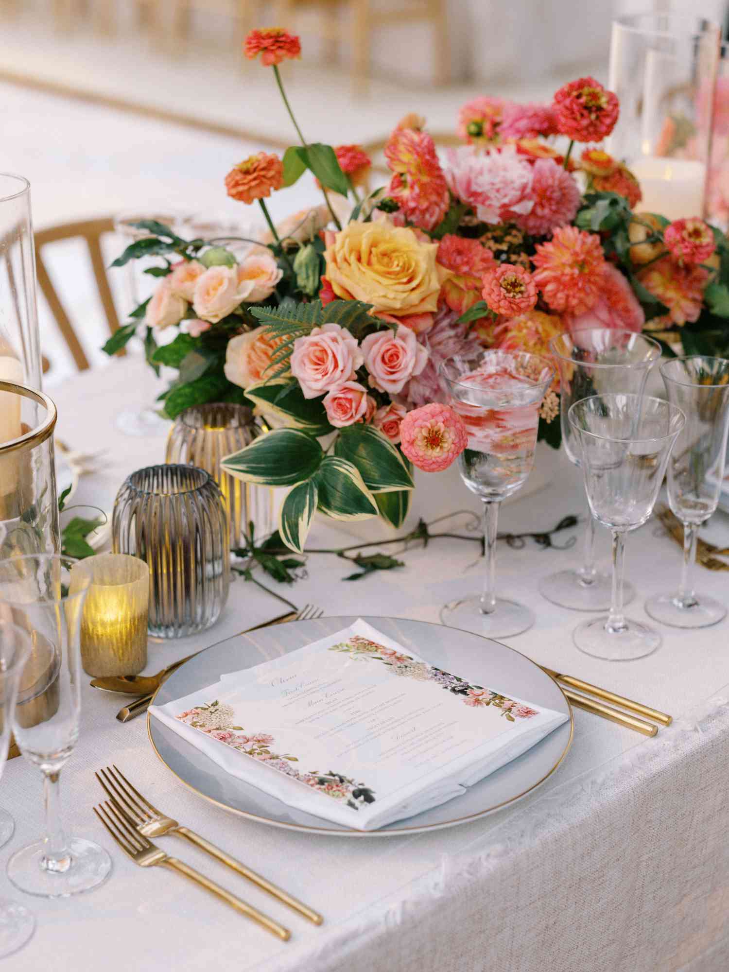 Wedding Reception Tables With Summer Floral Centerpiece of Roses, Dahlias, Zinnias, Ferns, and Greenery