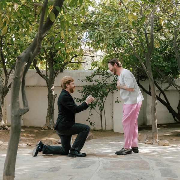 a man on one knee proposing to his partner