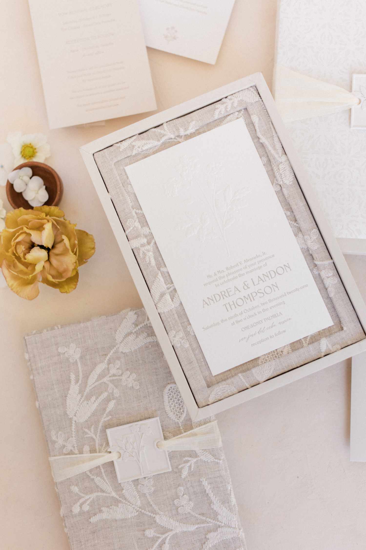 Lace and linen wedding invitation flat lay