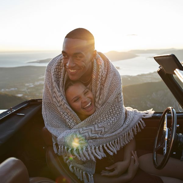 young couple in convertible hugging