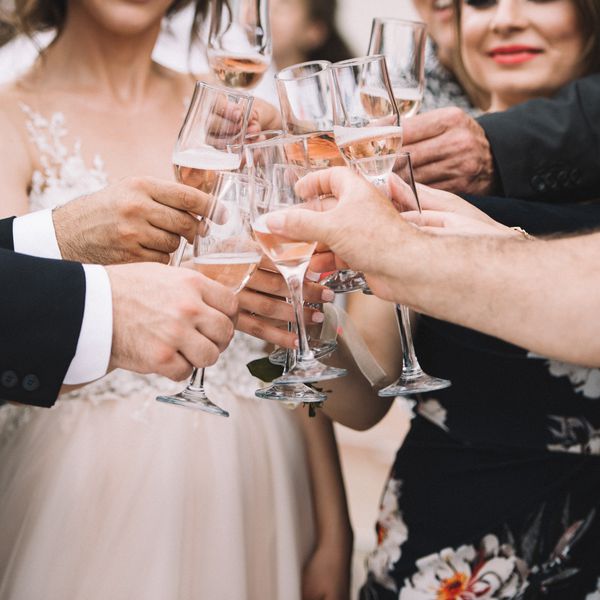 Bride, Groom, and Wedding Guests Toasting With Champagne Flutes