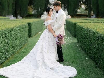 bride and groom posing in a grass maze
