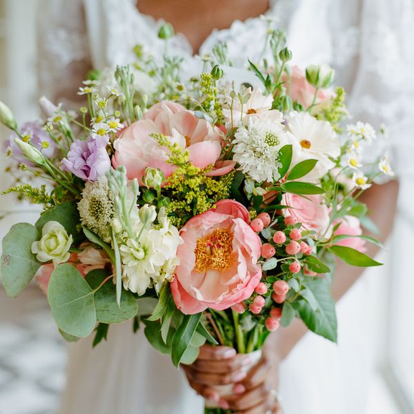 Bride Holds Peonies in a Wedding Bouquet