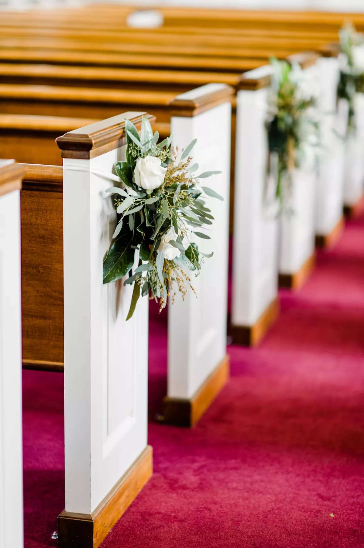 church pews with greenery