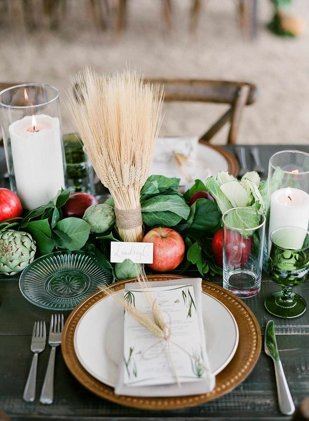 apples and greenery centerpiece on rustic wedding reception tabelscape