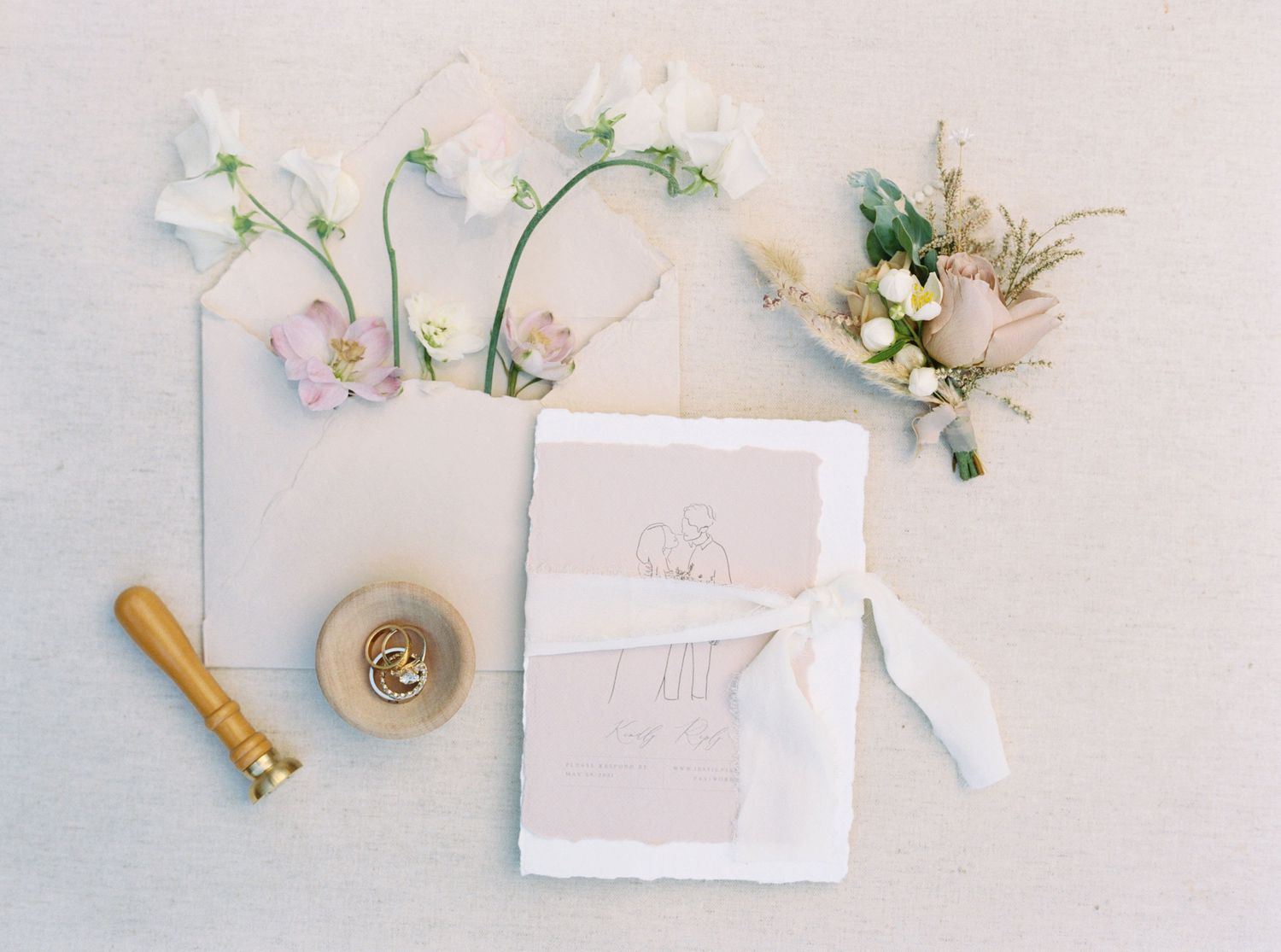 pastel pink wedding invitation with deckle edge and white ribbon