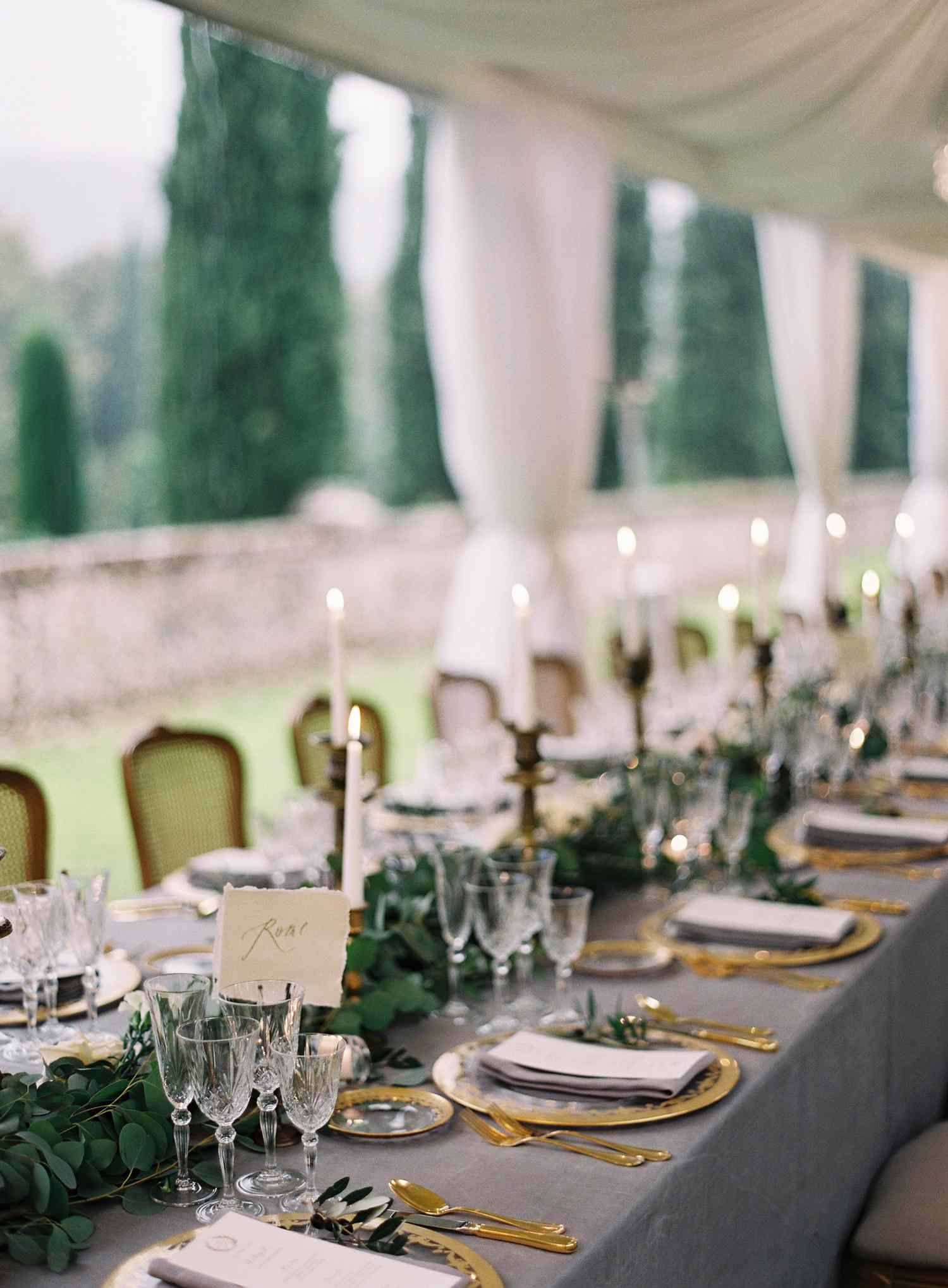 lush greenery runner centerpiece on gray tablescape with gold details