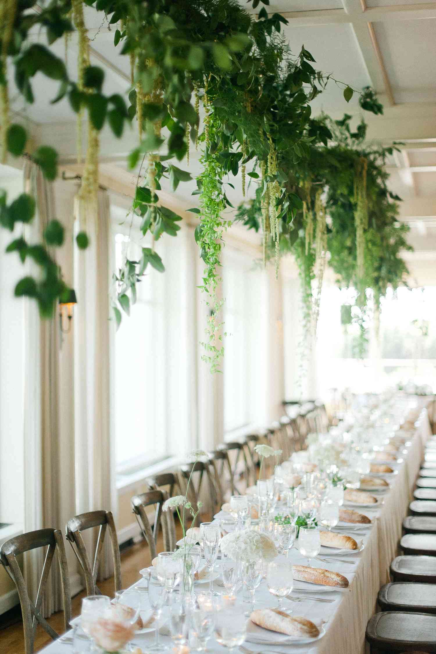hanging greenery centerpiece above minimalist wedding reception table