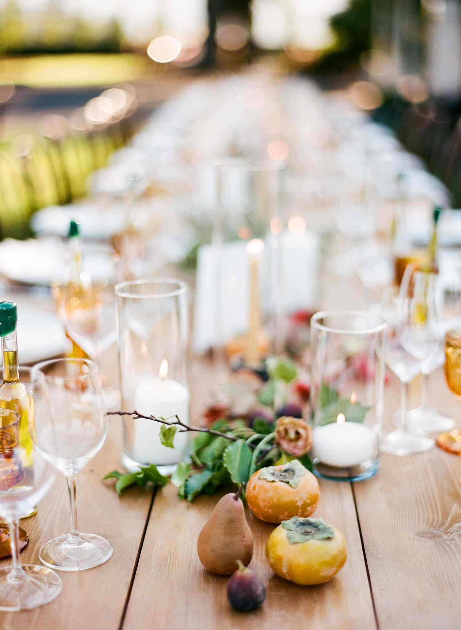 Pears and candles centerpiece on bare wood table