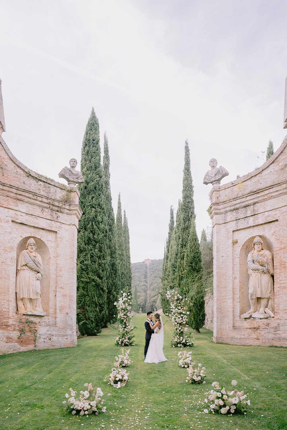 Bride and Groom Stand in an Embrace During Their Wedding at an Estate in Tuscany, Italy