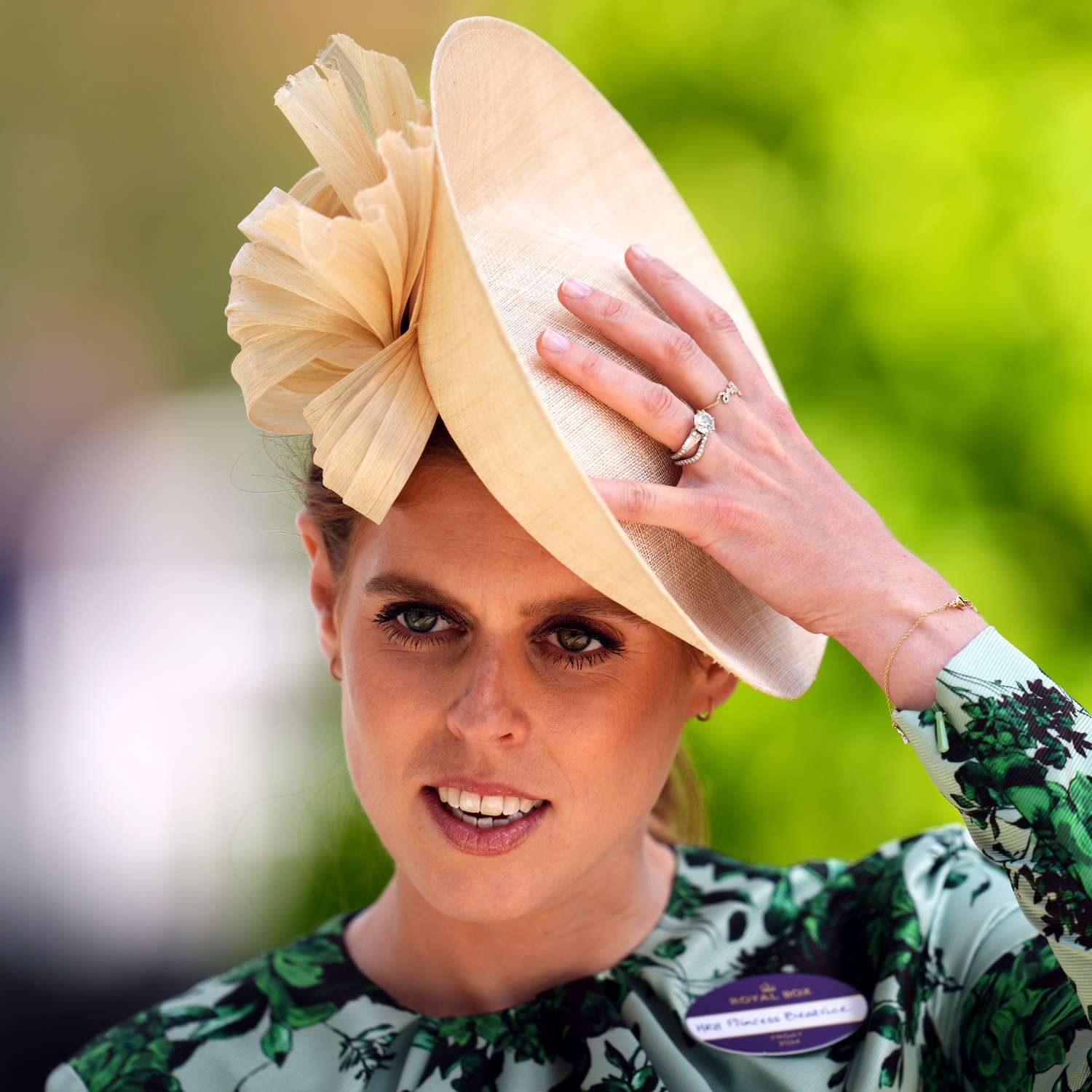 Princess Beatrice Wearing Cream Hat, Green Dress, and Showing Off Art Deco Engagement Ring