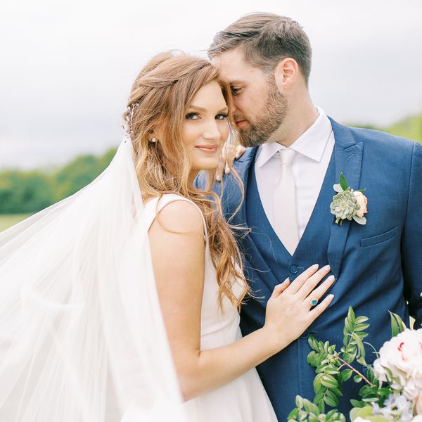 Bride and groom embracing outside on wedding day