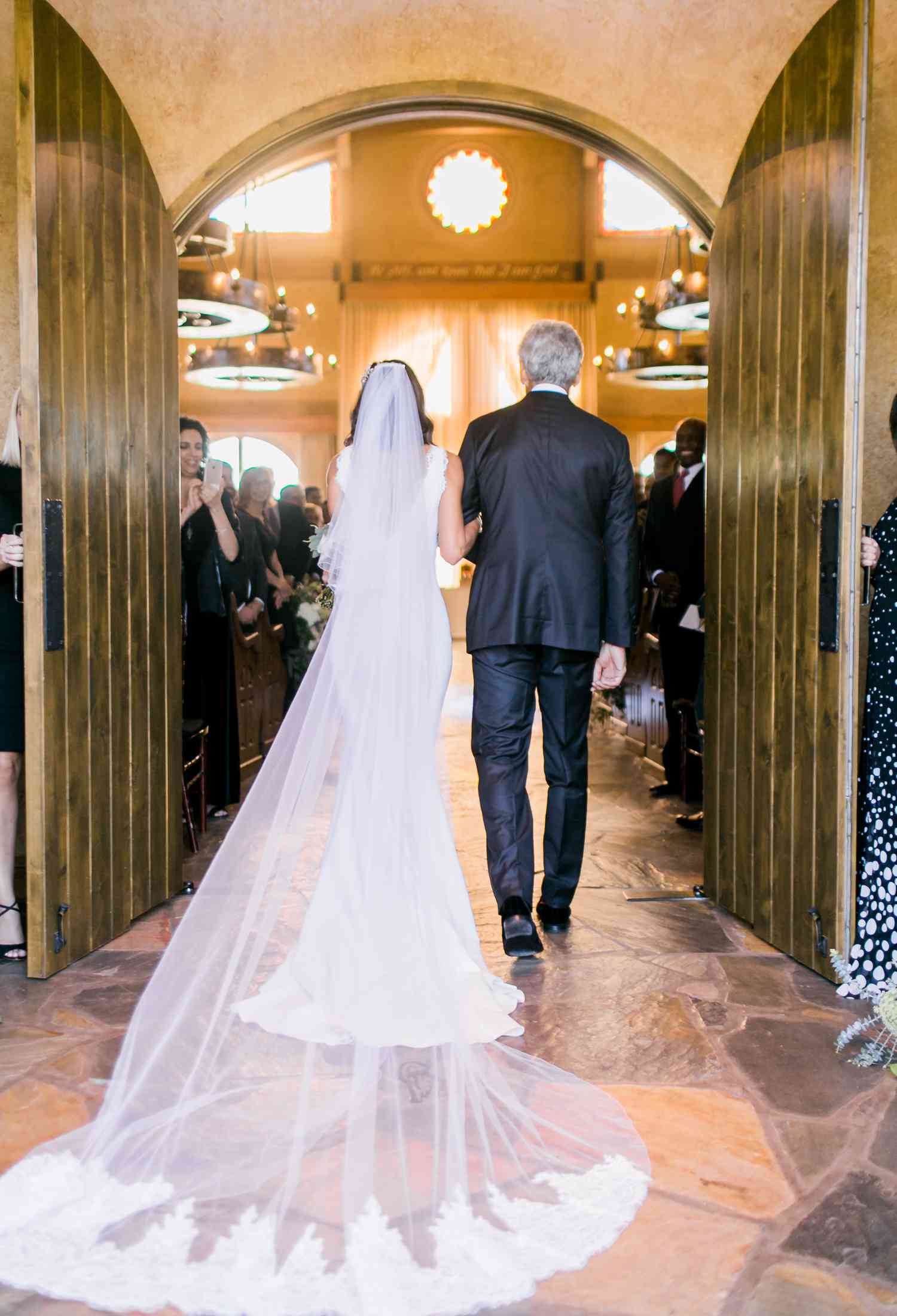 Bride and Father Walking Down the Aisle During Christian Wedding Ceremony Processional