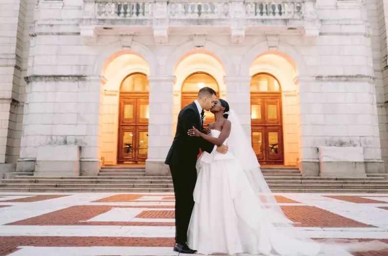 Couple kissing during evening in front of Providence Public Library in Rhode Island.
