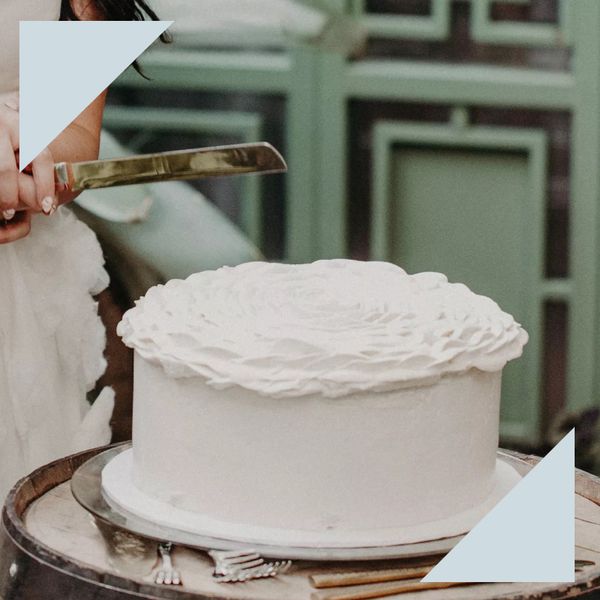 single-tier white wedding cake with large floral buttercream design