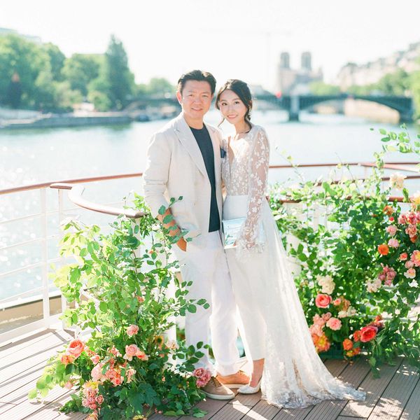 Angela and Allister on boat welcome cruise on the Seine River in Paris surrounded by rose bushes