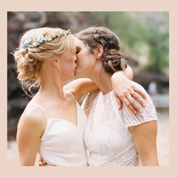 two brides kissing