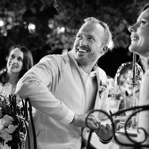 groom laughing while listening to speech
